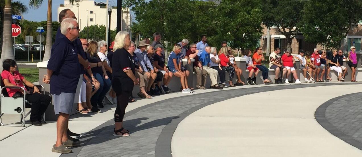 Onlookers observe Flag Day ceremony in Veterans Park, Punta Gorda